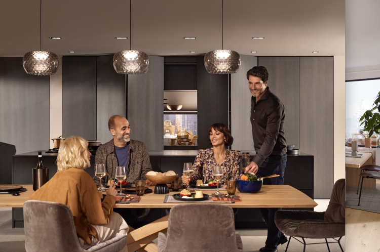 Familie sitzt mit essen am Tisch und ist glücklich